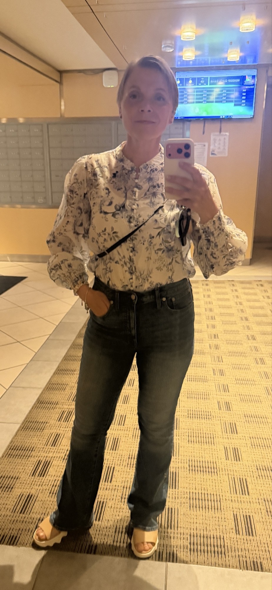 The aesthetic model, immediately prior to compilation. Floral blouse, indigo denim, platform sandals.